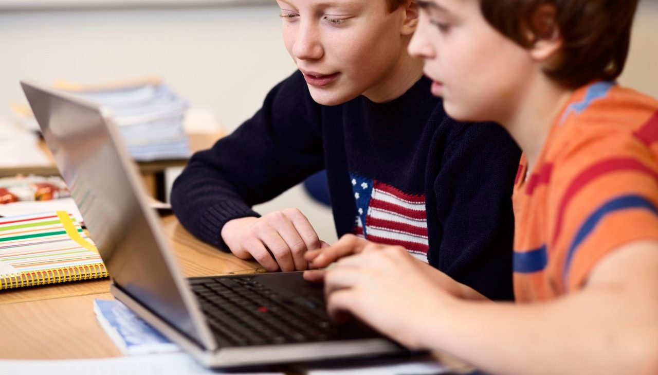 29 Nov 2013 --- High school boys using laptop at desk in classroom --- Image by © Maskot/Corbis