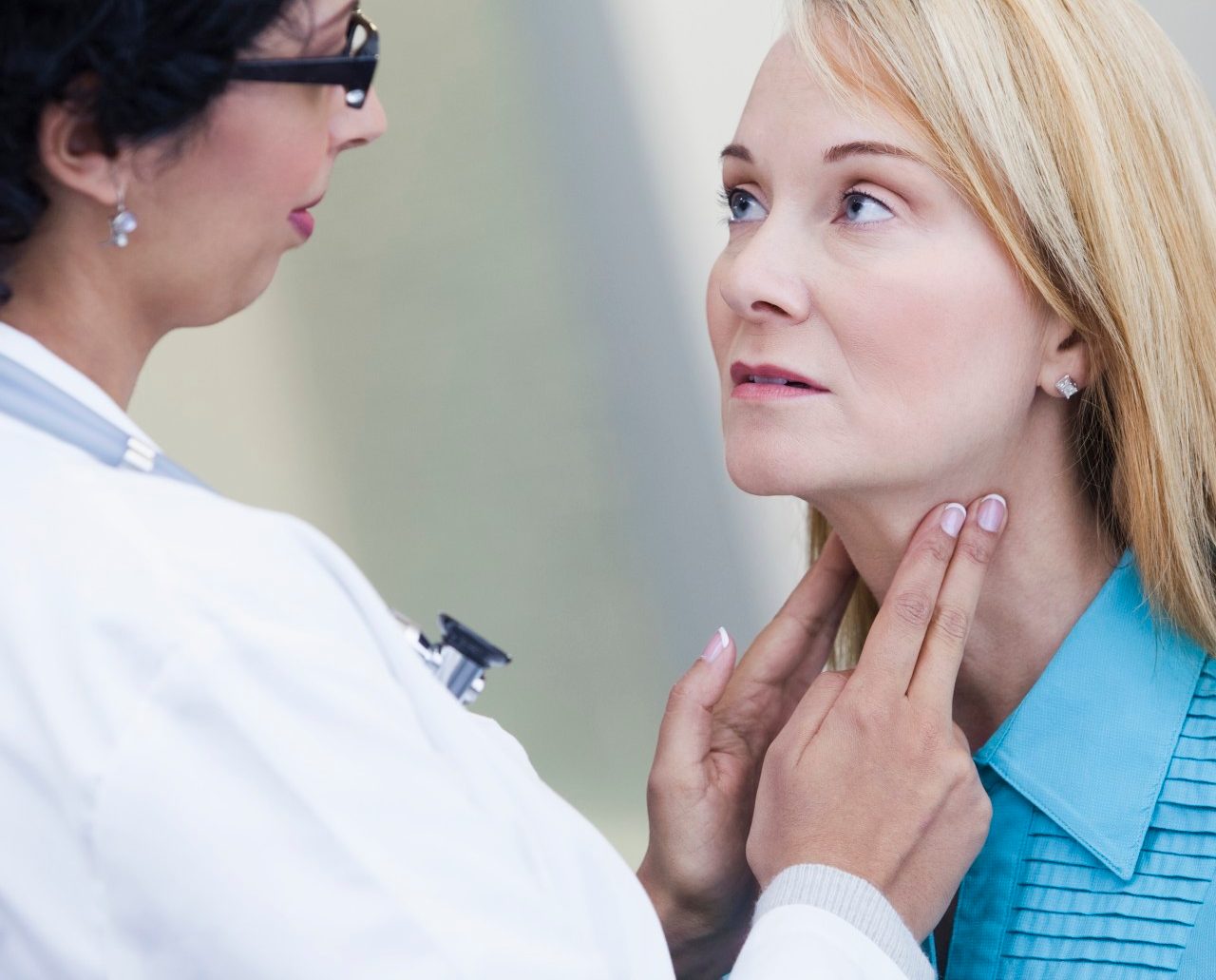 Doctor examining patient's lymph nodes --- Image by © Kate Kunz/Corbis